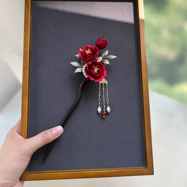Red Camellia — Velvet Flower Hairpin — the piece resting in soft light