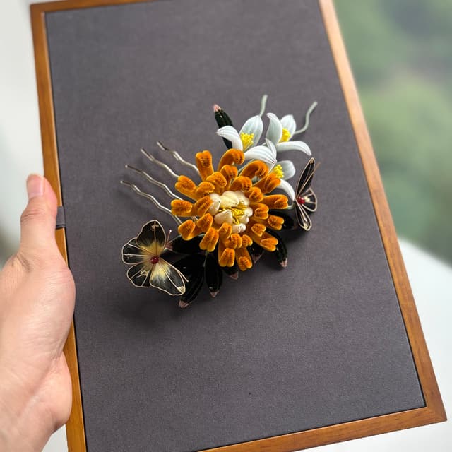 Golden Tangerine — Plush Chrysanthemum Comb — the piece resting in soft light