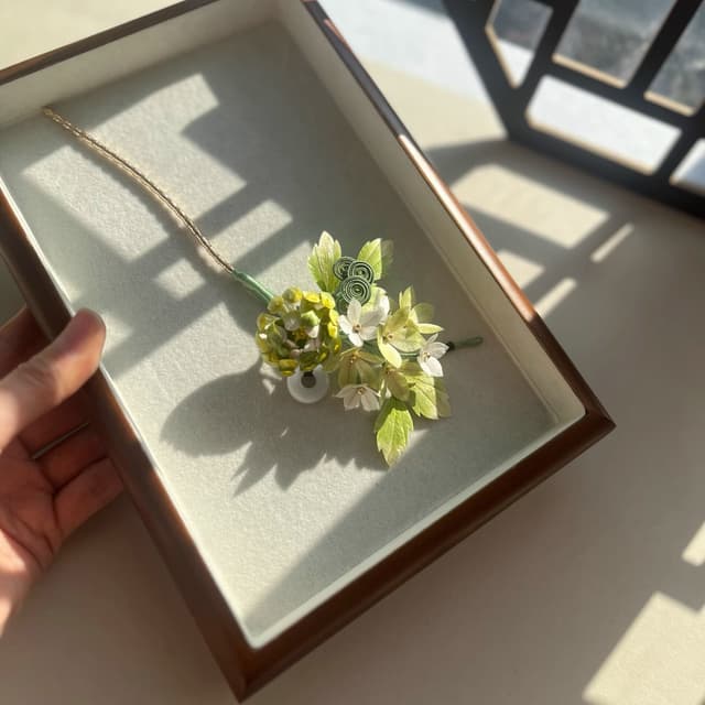 Green Chrysanthemum — Velvet Flower Comb — the piece resting in soft light